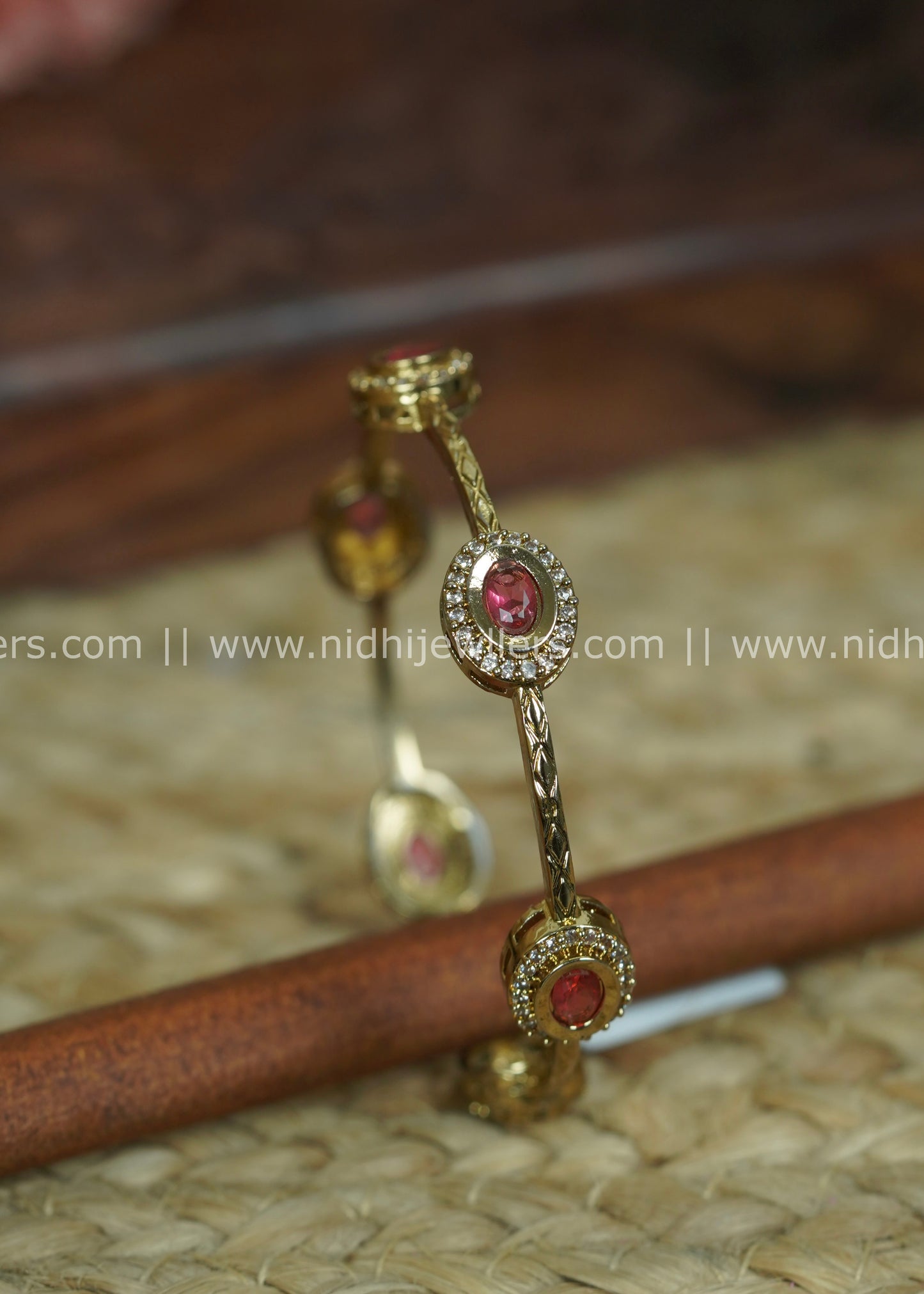 Gold-Tone Slender Chevron-Engraved Bangle with Ruby and White Stone Halos