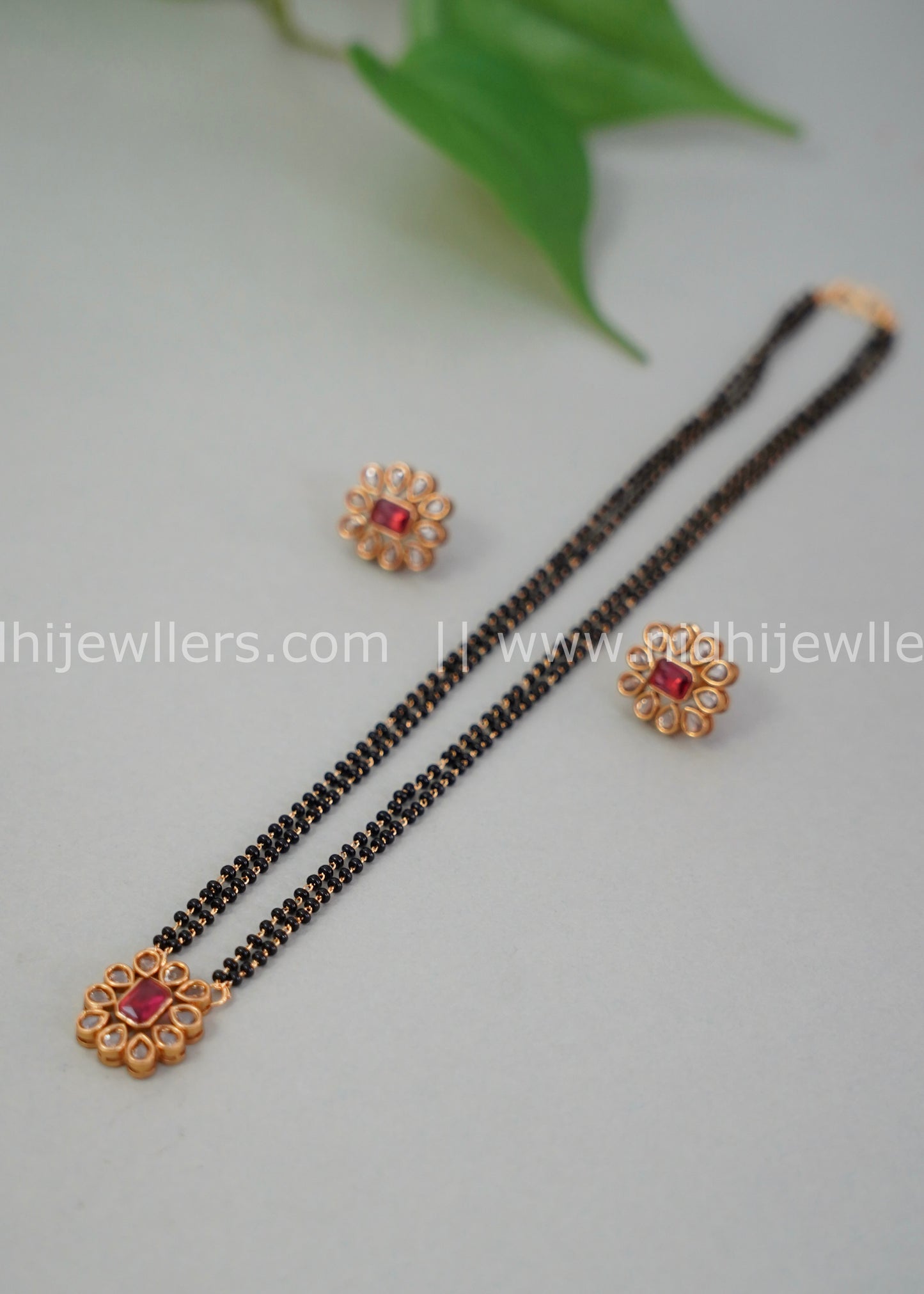 Black beads single layered floral neck piece.