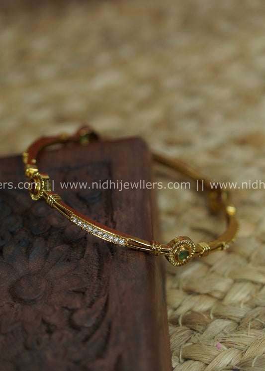 Slender Segmented Bangle with White Stone Channels and Ruby-Green Accents