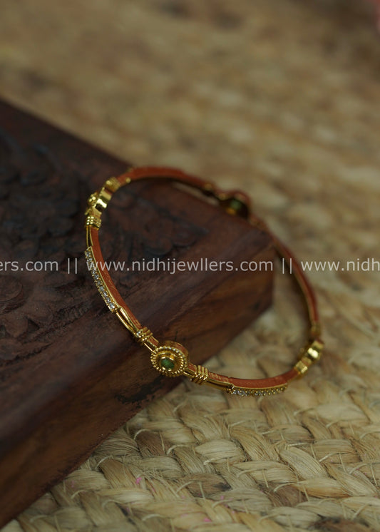 Slender Segmented Bangle with White Stone Channels and Ruby-Green Accents