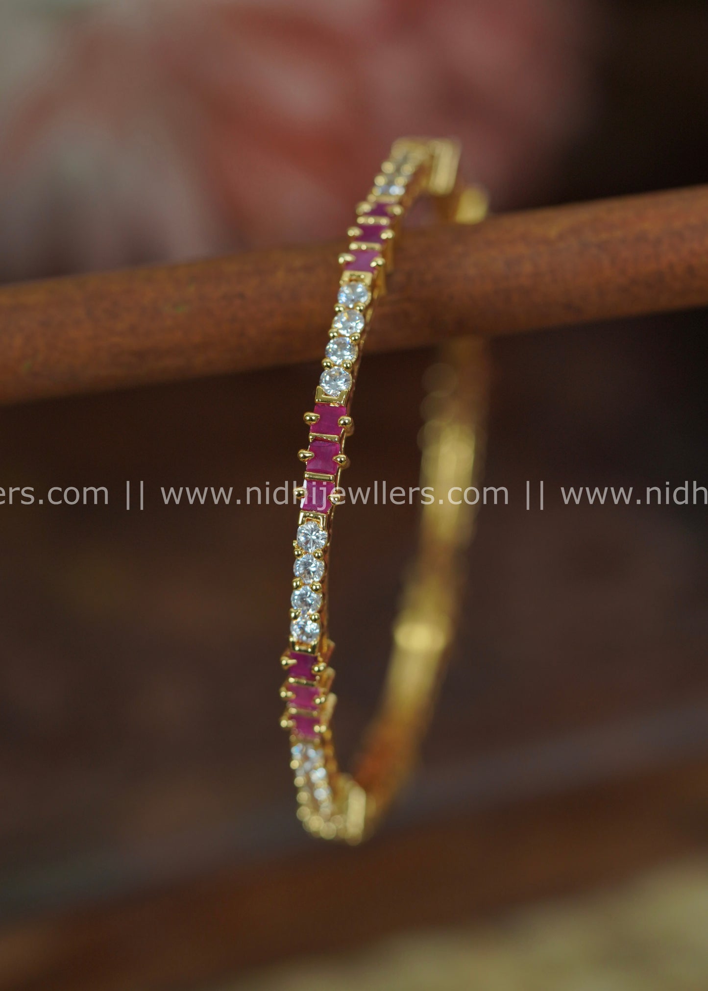 Gold-Color Slender Segmented Bangle with White Stone Blocks and Ruby Accents