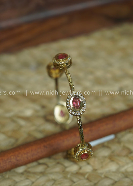 Gold-Tone Slender Chevron-Engraved Bangle with Ruby and White Stone Halos