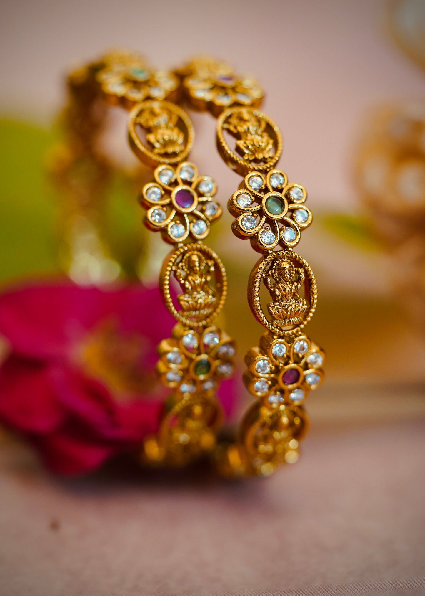 Floral Charm Bangles – Beautiful flower-shaped motifs with white stones and colored centers.
