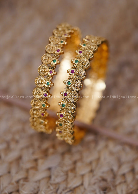 Traditional coin-style design with ruby and emerald stonework-thin