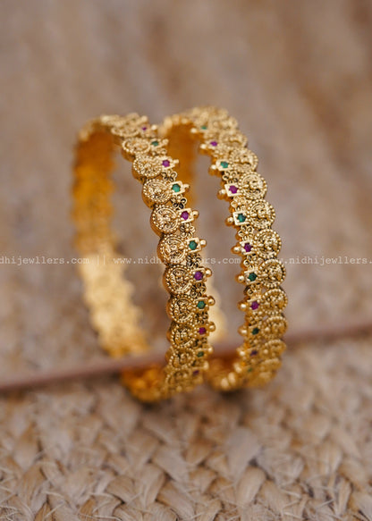 Traditional coin-style design with ruby and emerald stonework-thin